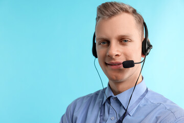 Technical support call center. Smiling operator on light blue background. Space for text