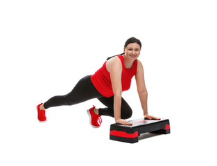 Plus size woman in gym clothes doing exercise with step platform on white background