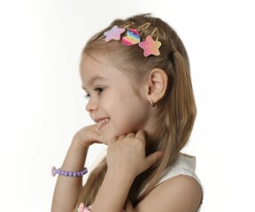 Cute little girl with beautiful hair clips on white background