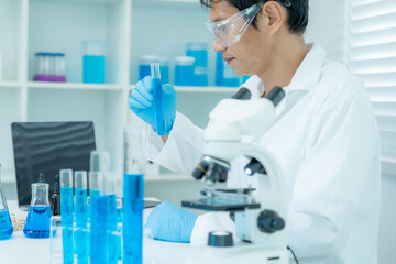Fototapeta premium Scientist analyze biochemical samples in advanced scientific laboratory. Medical professional use microscope look microbiological developmental of viral. Biotechnology research in science lab.
