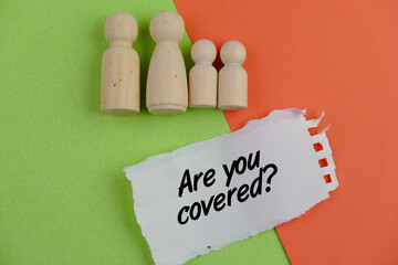 A torn notebook with the question "Are You Covered?" Copy space for text. Insurance coverage concept.