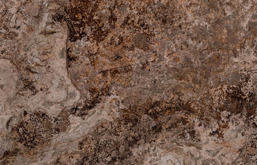 Natural stone wall texture in brown and beige color, close-up view with marked relief