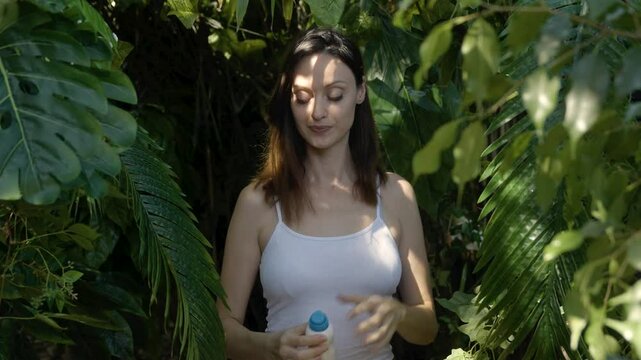 Girl is using deodorant spray for armpit skin