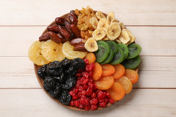 Different dried fruits on white wooden table, top view