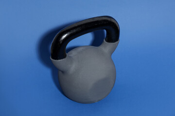One kettlebell on blue background. Sport equipment