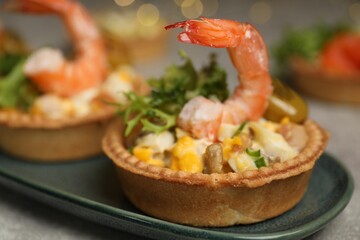 Tartlets with delicious filling on table, closeup. Bokeh effect