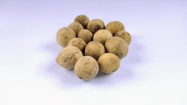 A group of Duku fruits or lanzones or Lansium domesticum on a white background
