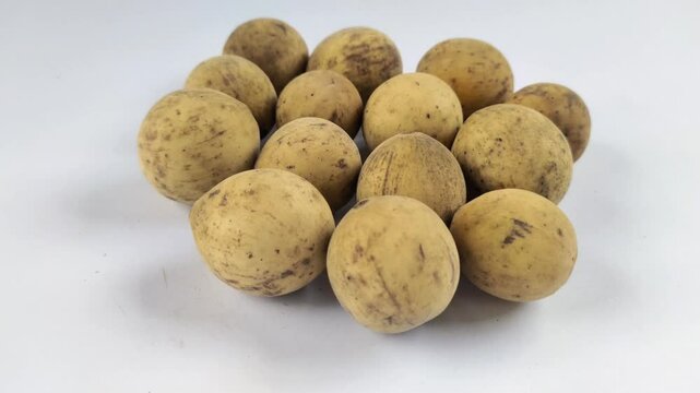 A group of Duku fruits or lanzones or Lansium domesticum on a white background