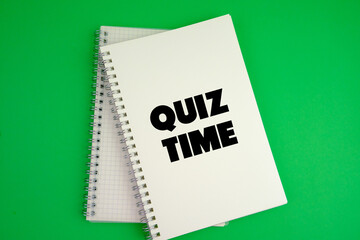 the words Quiz Time beside mini alarm clock on a plain background. the concept of answering quizzes or quiz games. text space