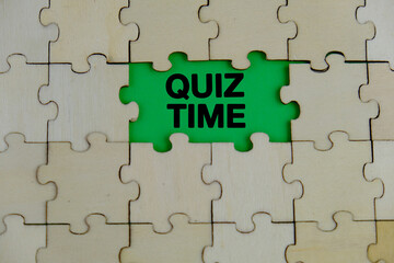 the words Quiz Time beside mini alarm clock on a plain background. the concept of answering quizzes...