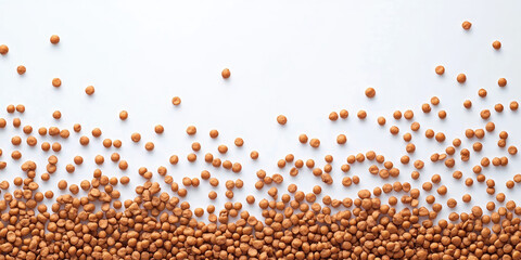 Naklejka premium Brown lentils scattered on a white surface, fading towards the top. Use for food blogs, cooking ingredients, or texture backgrounds with copy space.