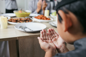 Raised Hands Praying Before Eating Together With Family On Eid Al Fitr Celebration
