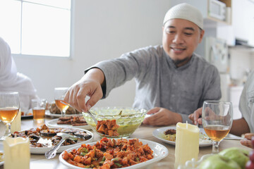 Portrait Of Young Muslim Man Taking Food To Eat On Eid Moment