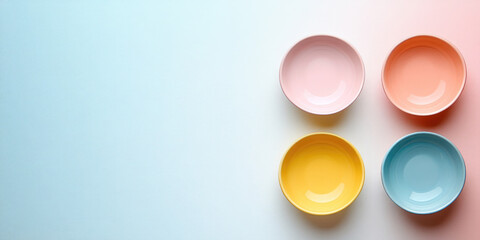 Colorful plates in on a white surface.  Kitchenware, tableware, and color themes. Ideal for home decor blogs, cooking sites, and design publications. Top view