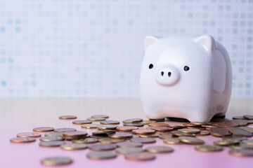 Piggy bank and pile of scattered coins.