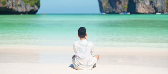 man tourist traveling and sightseeing in Krabi, Thailand, happy traveller enjoy at Maya Bay beach...