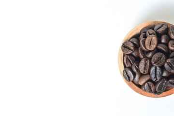 Flat lay of Roasted Coffee beans in little wooden bowl isolated on white background. Clipping path. Top view, Half view, copy space.