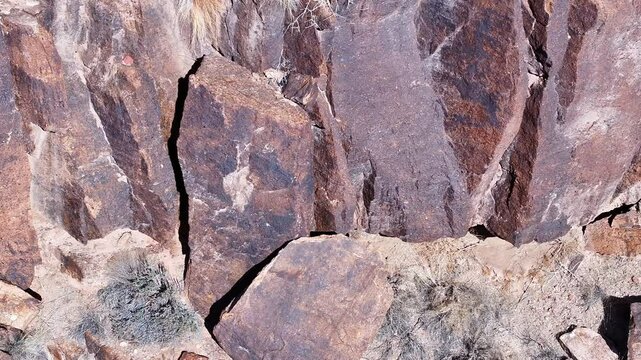 Aerial Virgin River gorge volcanic cliff Utah close fast. Southwestern desert Utah. Land of Shivwits Band Paiutes, Native American Indians. Geological erosion. Red sandstone black volcanic canyon.