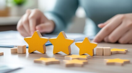 Three yellow star-shaped tokens are arranged on a table, with a person's hands visible in the background, suggesting a rating or evaluation process.