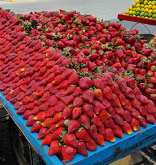 Ripe red strawberries stacked for sale on the street