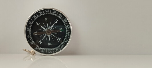 Navigating life compass close-up studio setting product photography minimalist environment top-down...