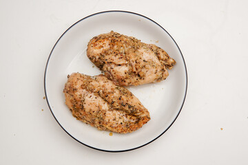 Roasted chicken breast with potato for diet menu on a plate, isolated white background.
