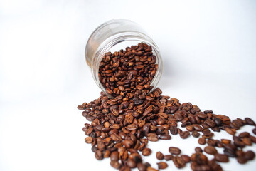 Coffee beans on a glass jar isolated on a white background