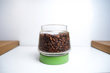 Coffee beans on a glass jar isolated on a white background