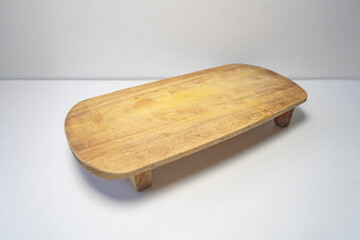 An oval wood chopping board  isolated on white background