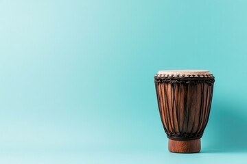 intricately carved djembe drum stands alone on vibrant turquoise backdrop