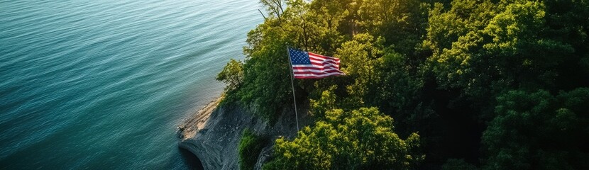 An American flag is flying on the cliff overlooking Lake Michigan, an aerial view captured by a drone.