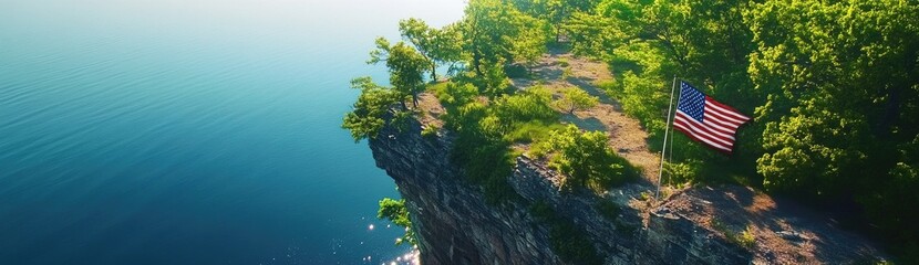 An American flag is flying on the cliff overlooking Lake Michigan, an aerial view captured by a drone.