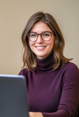 Young woman smiling while working on a laptop in a cozy indoor setting with soft lighting