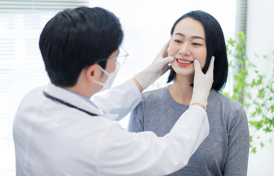 Smiling woman receiving dental care from a professional in a bright clinic setting during the day - Powered by Adobe