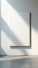 A minimalist space featuring a blank canvas on an illuminated wall.