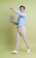 Professional Asian man presenting ideas with laptop in modern workspace