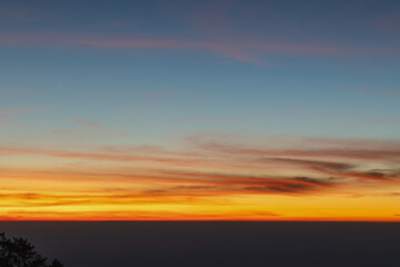 Heaven at early morning with copy space. Smooth orange blue gradient of dawn sky.Sunset, sunrise backdrop.Natural colors. Orange and red dramatic colors.