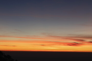 Heaven at early morning with copy space. Smooth orange blue gradient of dawn sky.Sunset, sunrise backdrop.Natural colors. Orange and red dramatic colors