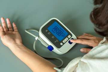 Man check blood pressure monitor and heart rate monitor with digital pressure gauge. Health care and Medical concept	