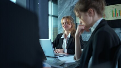 In the conference room, a group of businesspeople are discussing the follow-up meeting and the results of operations