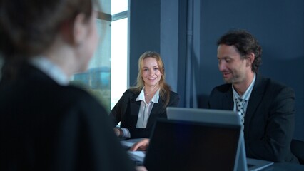 In the conference room, a group of businesspeople are discussing the follow-up meeting and the results of operations