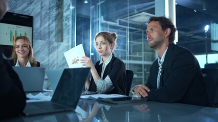 In the conference room, a group of businesspeople are discussing the follow-up meeting and the results of operations