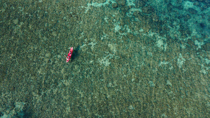 Aerial View of Kayak Floating Over Coral Reef.