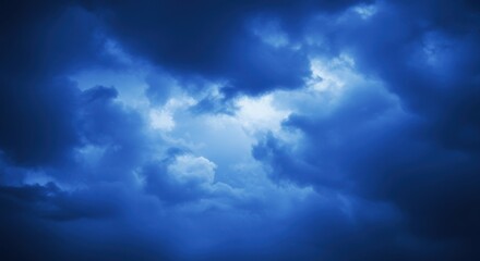dark stormy sky, ominous clouds, deep blue hues, dramatic lighting, moody atmosphere, ethereal cloudscape, turbulent weather, foreboding sky, celestial landscape, high contrast, textured clouds, atmos
