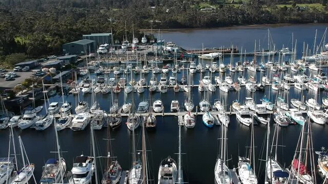 Aerial drone footage of Oyster Cove Marina and Little Kettering Marina, Bruny Island, Tasmania, showcasing boats, calm waters, scenic coastline, lush surroundings, and a tranquil harbor