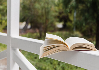 Open book on the front porch looking out to nature