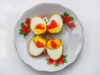 Fried eggs with chili sauce on a floral plate, Asian cuisine, traditional breakfast food photography