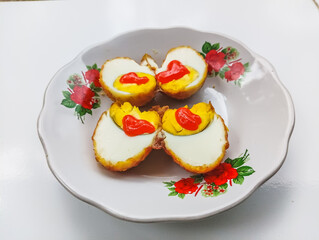 Fried eggs with chili sauce on a vintage floral plate, delicious food presentation