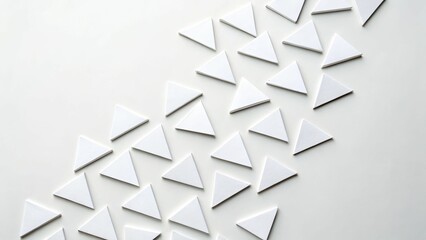 A minimal arrangement of scattered triangles forming a stylized upward arrow, suggesting growth, progress, and ambition