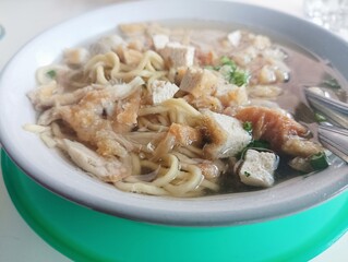 Delicious Indonesian Soto Ayam Soup with Noodles, Chicken, and Tofu for a Tasty Meal